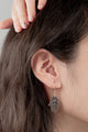 Close-up of the Hamsa Grace Earrings, featuring a finely detailed 30mm silver design with a polished finish.