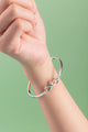 Close-up of the Infinity Cuff, showcasing a polished 4mm sterling silver band with a timeless, minimalist design