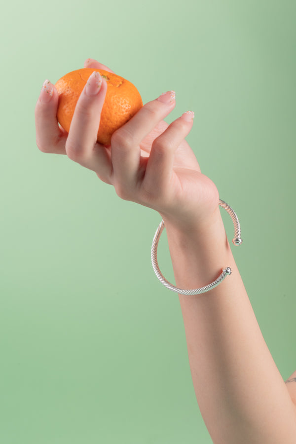 Close-up of the Lustrous Rope Cuff, showcasing a polished 4mm sterling silver band with an organic, twisted design