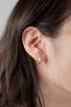 Close-up of the Minimal Loop Earrings, featuring a polished 20mm silver loop design for a timeless look