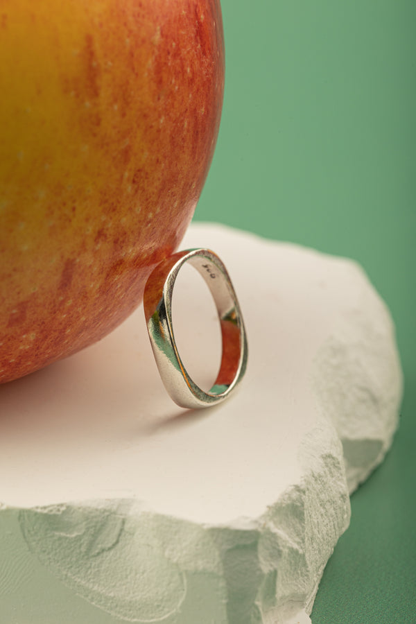 Close-up of Oval Edge Ring handcrafted from 925 sterling silver – lifestyle flat lay.