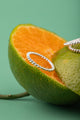 Close-up of handcrafted Twist Harmony Ring in 925 Sterling Silver on citrus background.