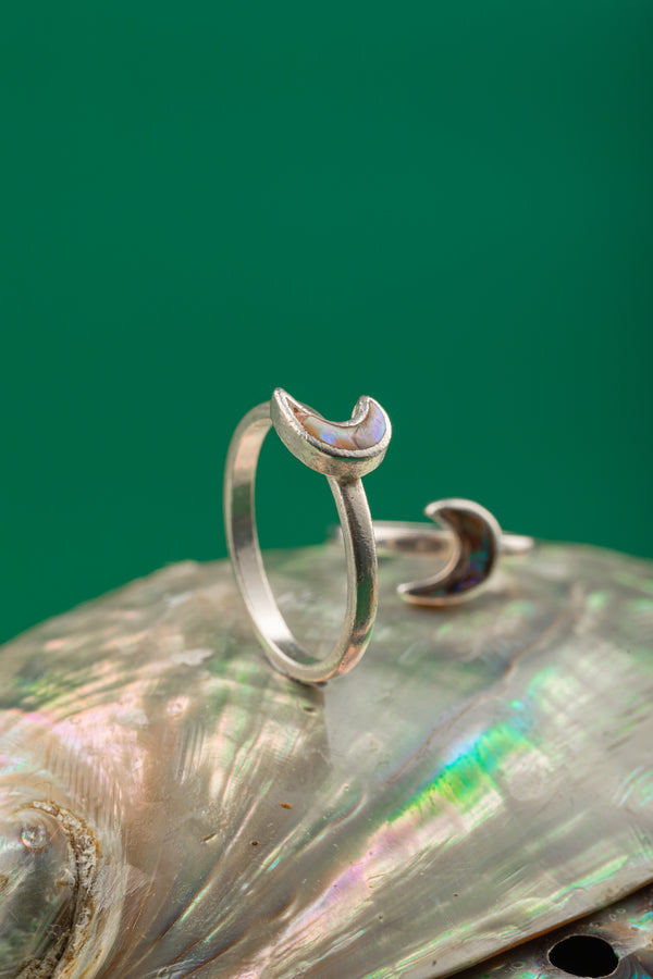 Elegant moon-inspired silver ring with curved band and subtle detailing