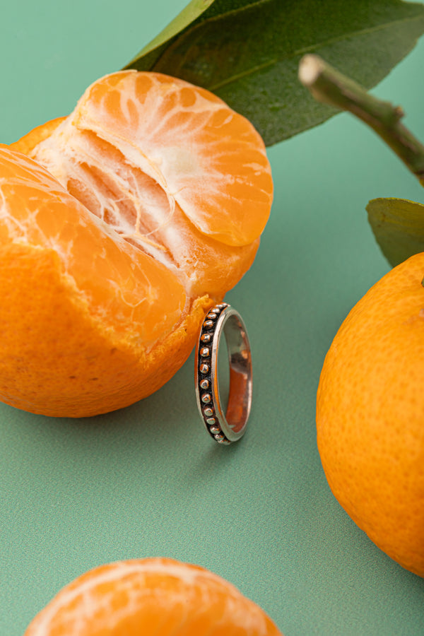 Handcrafted 925 silver ring with orange and yellow bead accents.

