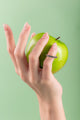 Close-up of minimalist silver ring adorned with vibrant citrus-colored beads